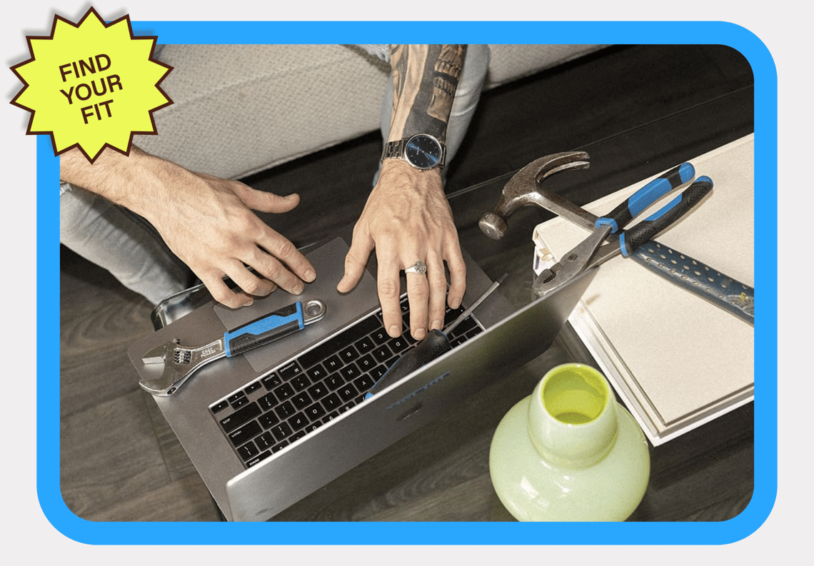 A man typing on this laptop with a sticker that reads 